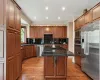 Chefs dream! Wood cabinetry, soft close drawers, Blanco double sink, SS appliances,  granite counters, large island, Oak floors, wood window looking onto beautiful garden.