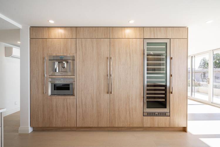 Integrated Thermador fridge/freezer, built-in coffee machine, microwave and wine fridge. Pull out pantry cabinetry