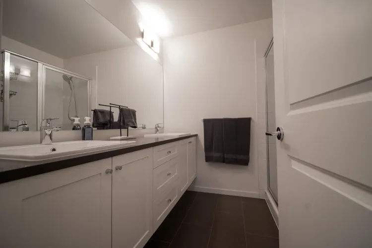 The primary bathroom features dual sinks, offering added convenience and a touch of elegance.