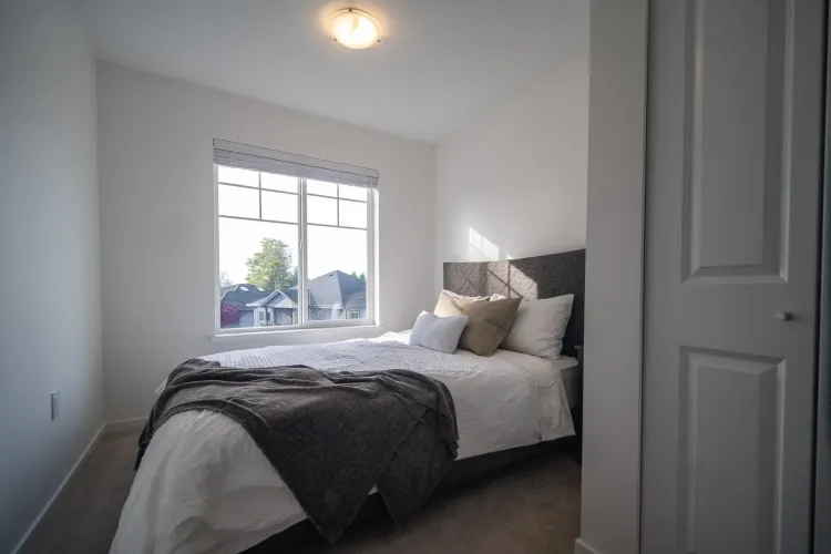 This bedroom, facing the front of the home, offers enhanced privacy and a peaceful retreat.